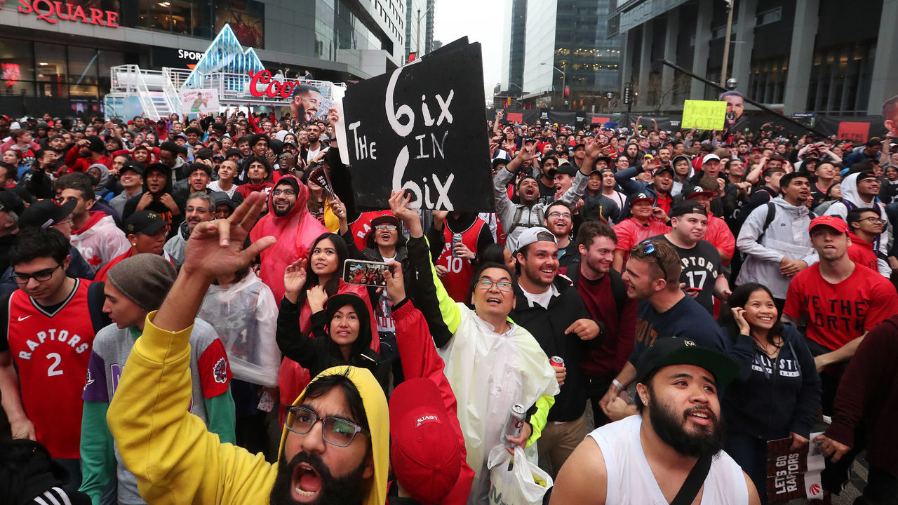 TORONTO, ON- MAY 25 - Toronto fans, some with signs and Drake cutouts, cheer in Jurassic Park as the Toronto Raptors play the Milwaukee Bucks in game six of the NBA Eastern Conference Final in Toronto. May 25, 2019. (Steve Russell/Toronto Star via Getty Images)