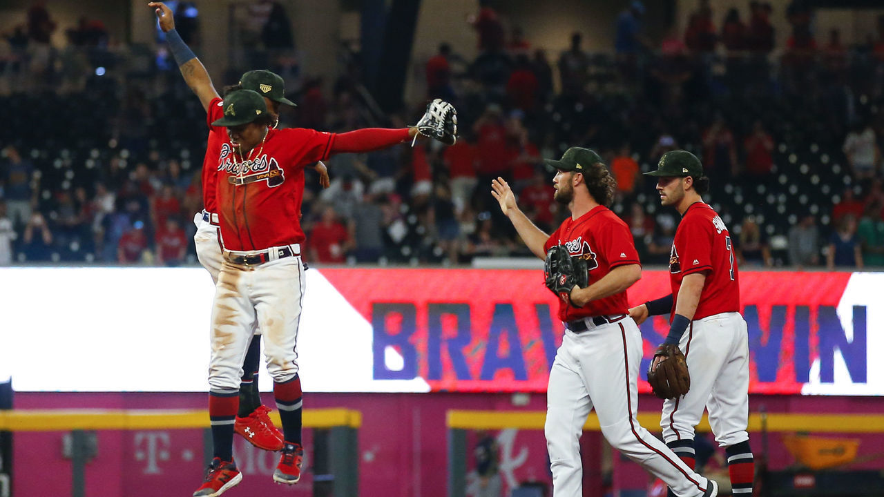 ATLANTA, GA - MAY 17: Ronald Acuna Jr. #13 of the Atlanta Braves celebrates the win with Ozzie Albies #1 at the conclusion of an MLB game against the Milwaukee Brewers at SunTrust Park on May 17, 2019 in Atlanta, Georgia.