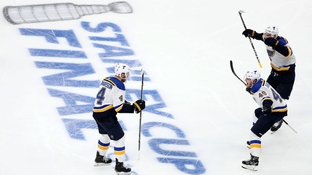 BOSTON, MASSACHUSETTS - MAY 29: Carl Gunnarsson #4 of the St. Louis Blues is congratulated by his teammates Ivan Barbashev #49 and Alex Pietrangelo #27 after scoring the game winning goal during the first overtime period against the Boston Bruins in Game Two of the 2019 NHL Stanley Cup Final at TD Garden on May 29, 2019 in Boston, Massachusetts.