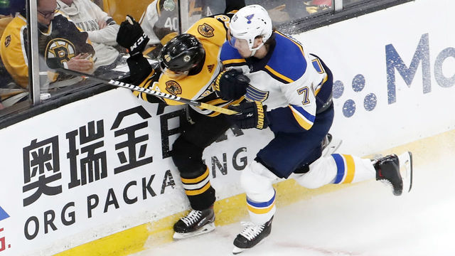 BOSTON, MA - MAY 29: St. Louis Blues center Oskar Sundqvist (70) readys a shoulder into Boston Bruins left defenseman Matt Grzelcyk (48) and puts him out of the game during Game 2 of the 2019 Stanley Cup Finals between the Boston Bruins and the St. Louis Blues on May 29, 2019, at TD Garden in Boston, Massachusetts.