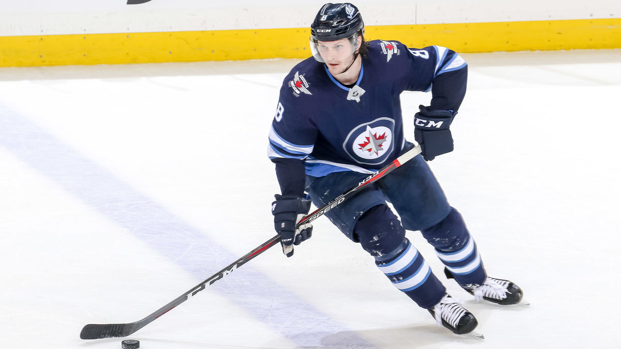 WINNIPEG, MB - MARCH 28: Jacob Trouba #8 of the Winnipeg Jets plays the puck up the ice during third period action against the New York Islanders at the Bell MTS Place on March 28, 2019 in Winnipeg, Manitoba, Canada. The Isles defeated the Jets 5-4.