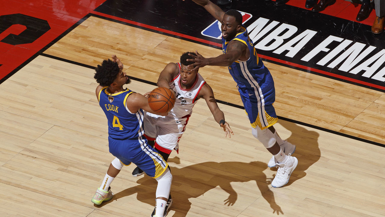 TORONTO, CANADA - MAY 30: Kyle Lowry #7 of the Toronto Raptors passes the ball while guarded by Quinn Cook #4 and Draymond Green #23 of the Golden State Warriors during Game One of the NBA Finals on May 30, 2019 at Scotiabank Arena in Toronto, Ontario, Canada. NOTE TO USER: User expressly acknowledges and agrees that, by downloading and/or using this photograph, user is consenting to the terms and conditions of the Getty Images License Agreement. Mandatory Copyright Notice: Copyright 2019 NBAE