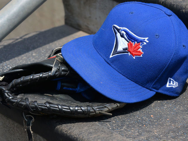 DETROIT, MI - JULY 16: A detailed view of a Toronto Blue Jays baseball hat and glove sitting on the dugout steps during the game against the Detroit Tigers at Comerica Park on July 16, 2017 in Detroit, Michigan. The Tigers defeated the Blue Jays 6-5.