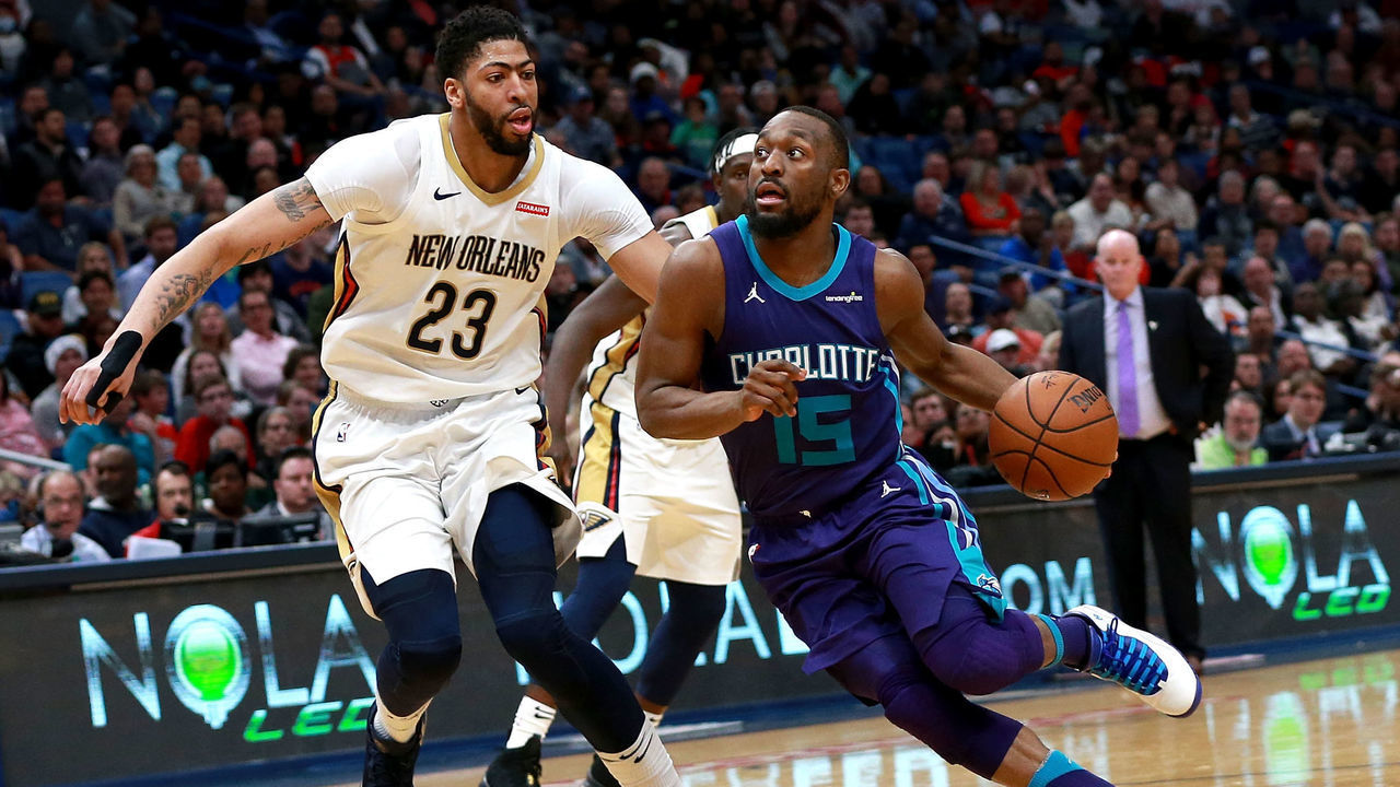 NEW ORLEANS, LA - MARCH 13: Kemba Walker #15 of the Charlotte Hornets drives the ball past Anthony Davis #23 of the New Orleans Pelicans during the second half of a NBA game at the Smoothie King Center on March 13, 2018 in New Orleans, Louisiana.