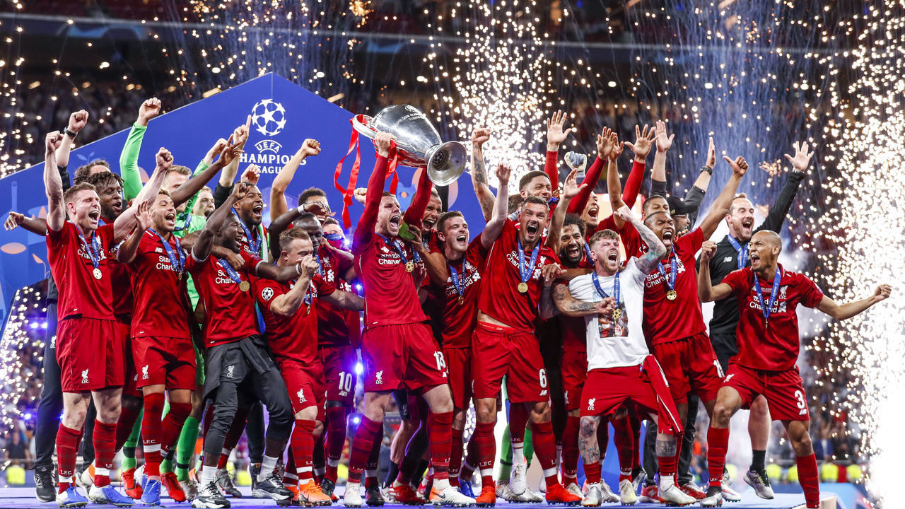 MADRID, SPAIN - JUNE 1: Alisson Becker of Liverpool FC, Fabinho of Liverpool FC, Virgil van Dijk of Liverpool FC, Georginio Wijnaldum of Liverpool FC, Roberto Firmino of Liverpool FC, Sadio Mane of Liverpool FC, Mohamed Salah of Liverpool FC, Jordan Henderson of Liverpool FC, Andy Robertson of Liverpool FC, Joel Matip of Liverpool FC, Trent Alexander-Arnold of Liverpool FC, Simon Mignolet of Liverpool FC, Dejan Lovren of Liverpool FC, James Milner of Liverpool FC, Joe Gomez of Liverpool FC, Daniel Sturridge of Liverpool FC, Alberto Moreno of Liverpool FC, Adam Lallana of Liverpool FC, Alex Oxlade Chamberlain of Liverpool FC, Xherdan Shaqiri of Liverpool FC, , Divock Origi of Liverpool FC assistent trainer Pepijn Lijnders of Liverpool FC, coach Jurgen Klopp of Liverpool FC, celebrates the championship with the Trophy during the UEFA Champions League match between Tottenham Hotspur v Liverpool at the Wanda Metropolitano on June 1, 2019 in Madrid Spain