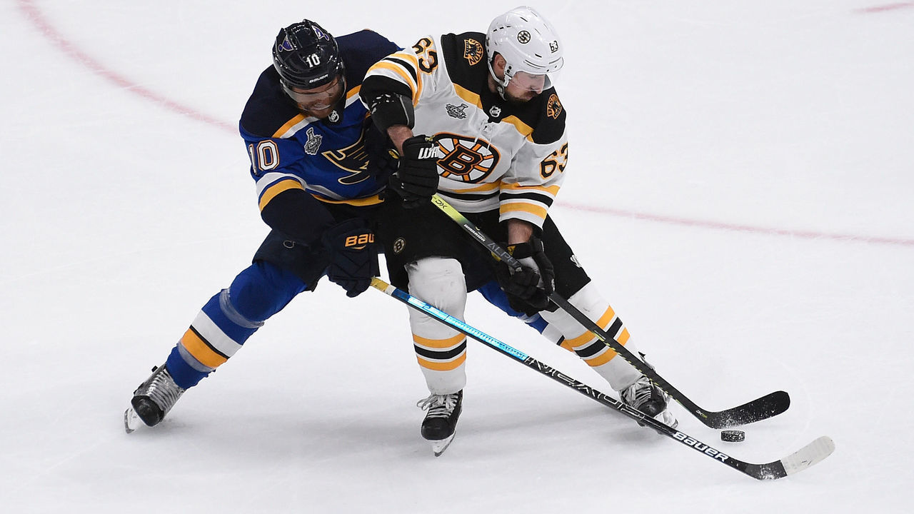ST. LOUIS, MO - JUNE 1: Brayden Schenn #10 of the St. Louis Blues and Brad Marchand #63 of the Boston Bruins battle for the puck in Game Three of the 2019 NHL Stanley Cup Final at Enterprise Center on June 1, 2019 in St. Louis, Missouri.