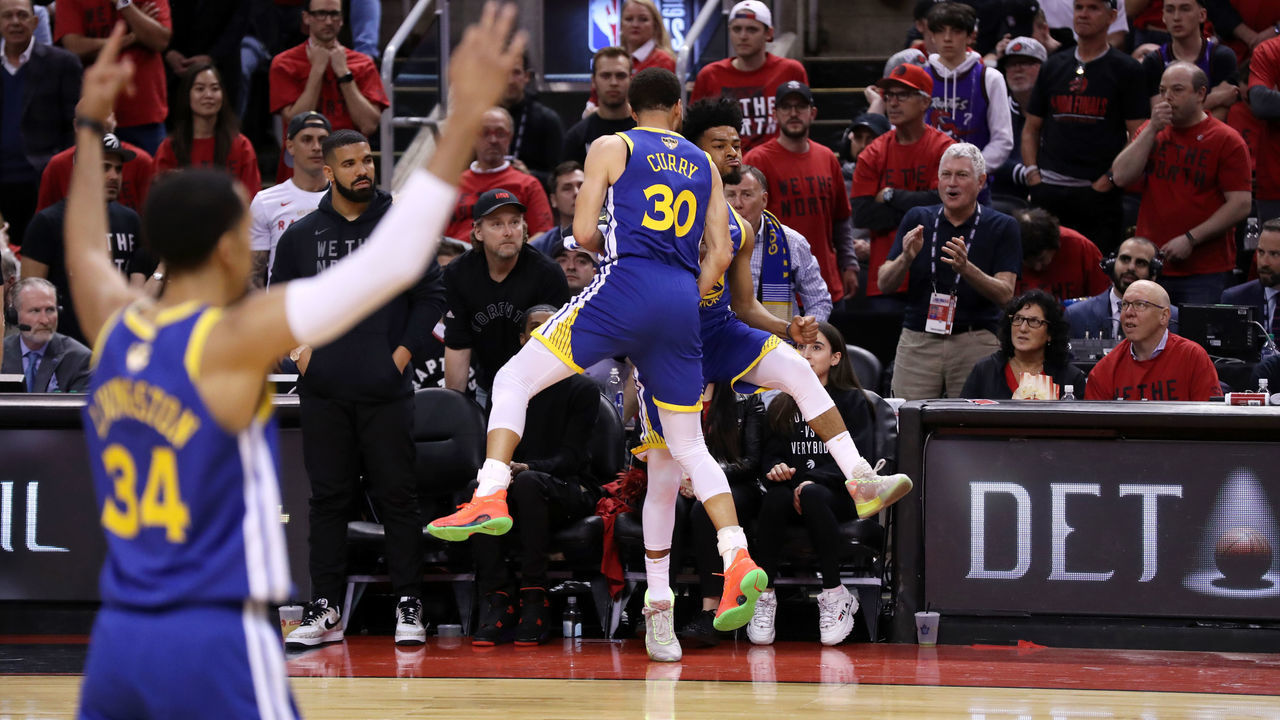 TORONTO, CANADA - JUNE 2: Stephen Curry #30 and Quinn Cook #4 of the Golden State Warriors react to a three point basket against the Toronto Raptors during Game Two of the NBA Finals on June 2, 2019 at Scotiabank Arena in Toronto, Ontario, Canada. NOTE TO USER: User expressly acknowledges and agrees that, by downloading and/or using this photograph, user is consenting to the terms and conditions of the Getty Images License Agreement. Mandatory Copyright Notice: Copyright 2019 NBAE