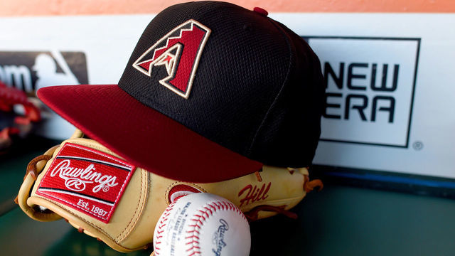 SAN FRANCISCO, CA - APRIL 17: The cap and Rawlings baseball glove belonging to Aaron Hill #2 of the Arizona Diamondbacks sits in the dugout prior to the game against the San Francisco Giants at AT&T Park on April 17, 2015 in San Francisco, California. The Diamondbacks won the game 9-0.