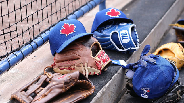TAMPA, FL - MARCH 23: A detailed viewof the baseball caps and gloves from members of the Toronto Blue Jays during the game at George M. Steinbrenner Field on March 23, 2014 in Tampa, Florida. The Blue Jays defeated the Yankees 3-1.
