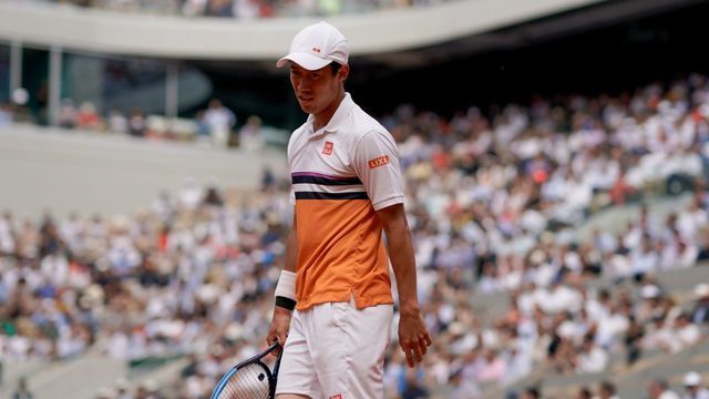 Japan's Kei Nishikori reacts during his men's singles quarter-final match against Spain's Rafael Nadal, on day ten of The Roland Garros 2019 French Open tennis tournament in Paris on June 4, 2019.