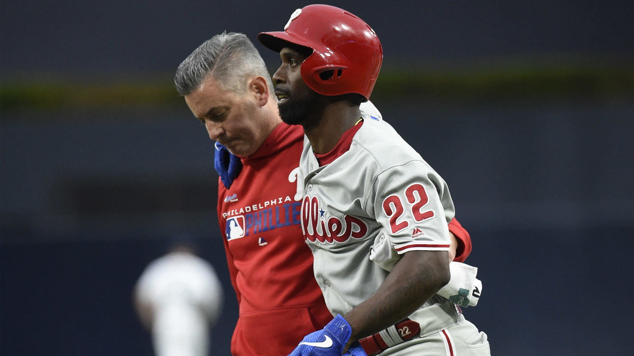 SAN DIEGO, CA - JUNE 3: Andrew McCutchen #22 of the Philadelphia Phillies is helped off the field by a trainer during the first inning of a baseball game against the San Diego Padres at Petco Park June 3, 2019 in San Diego, California.