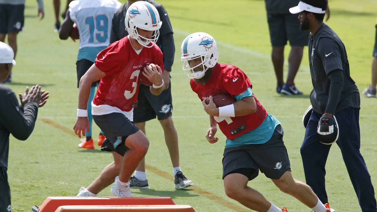 DAVIE, FL - MAY 14: Josh Rosen #3 and Ryan Fitzpatrick #14 of the Miami Dolphins run a drill during the Miami Dolphins OTA"u2019s on May 14, 2019 at the Miami Dolphins training facility in Davie, Florida.