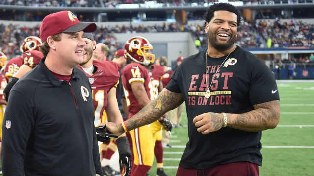 DALLAS, TX - JANUARY, 3: Washington Redskins tackle Trent Williams (71) congratulates head coach Jay Gruden as time runs out on their victory over the Dallas Cowboys at AT&T Stadium on January 3, 2016 in Dallas, TX. (Jonathan Newton / The Washington Post via Getty Images)