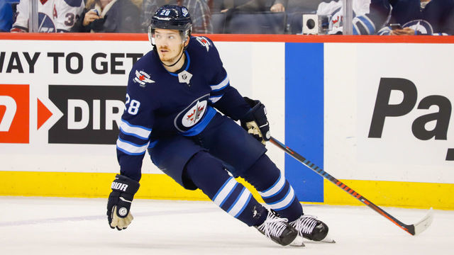 WINNIPEG, MB - FEBRUARY 5: Jack Roslovic #28 of the Winnipeg Jets keeps an eye on the play during first period action against the San Jose Sharks at the Bell MTS Place on February 5, 2019 in Winnipeg, Manitoba, Canada. The Sharks defeated the Jets 3-2 in overtime.