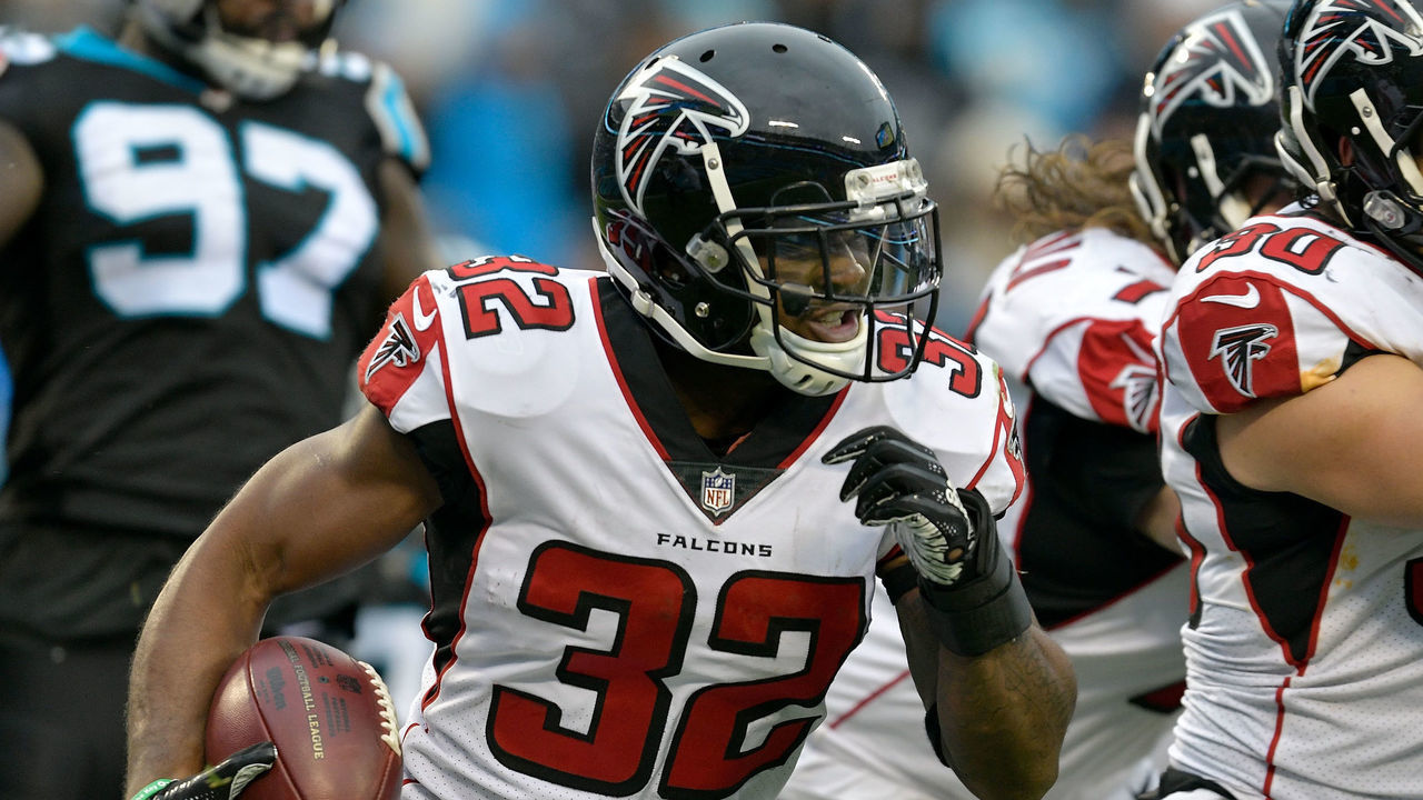 CHARLOTTE, NORTH CAROLINA - DECEMBER 23: Brian Hill #32 of the Atlanta Falcons runs the ball against the Carolina Panthers in the fourth quarter during their game at Bank of America Stadium on December 23, 2018 in Charlotte, North Carolina.