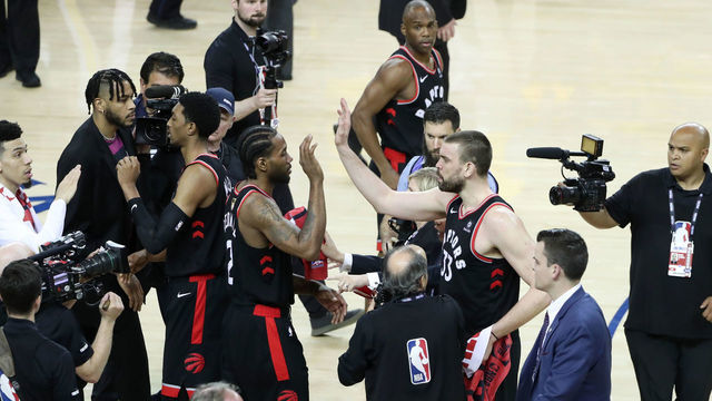 OAKLAND, CA - JUNE 5: Kawhi Leonrd #2 hi-fives Marc Gasol #33 of the Toronto Raptors after the Toronto Raptors win the game against the Golden State Warriors in Game Three of the NBA Finals to lead the series 2-1 on June 5, 2019 at ORACLE Arena in Oakland, California. NOTE TO USER: User expressly acknowledges and agrees that, by downloading and/or using this photograph, user is consenting to the terms and conditions of Getty Images License Agreement. Mandatory Copyright Notice: Copyright 2019 NBAE