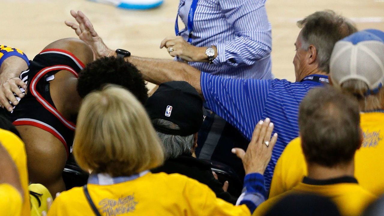 OAKLAND, CALIFORNIA - JUNE 05: Kyle Lowry #7 of the Toronto Raptors is pushed by Warriors minority investor Mark Stevens (blue shirt) after falling into the seats after a play against the Golden State Warriors in the second half during Game Three of the 2019 NBA Finals at ORACLE Arena on June 05, 2019 in Oakland, California. According to to the Warriors, Stevens will not be in attendance for the remainder of the NBA Finals as they look further into the incident.