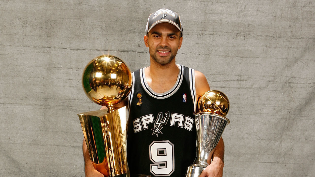 CLEVELAND - JUNE 14: Finals MVP Tony Parker #9 of the San Antonio Spurs pose for a portrait with the Larry O'Brien Championship trophy after they won the 2007 NBA Championship with their 83-82 win against the Cleveland Cavaliers in Game Four of the NBA Finals at the Quicken Loans Arena on June 14, 2007 in Cleveland, Ohio. NOTE TO USER: User expressly acknowledges and agrees that, by downloading and/or using this Photograph, user is consenting to the terms and conditions of the Getty Images License Agreement. Mandatory Copyright Notice: Copyright 2007 NBAE