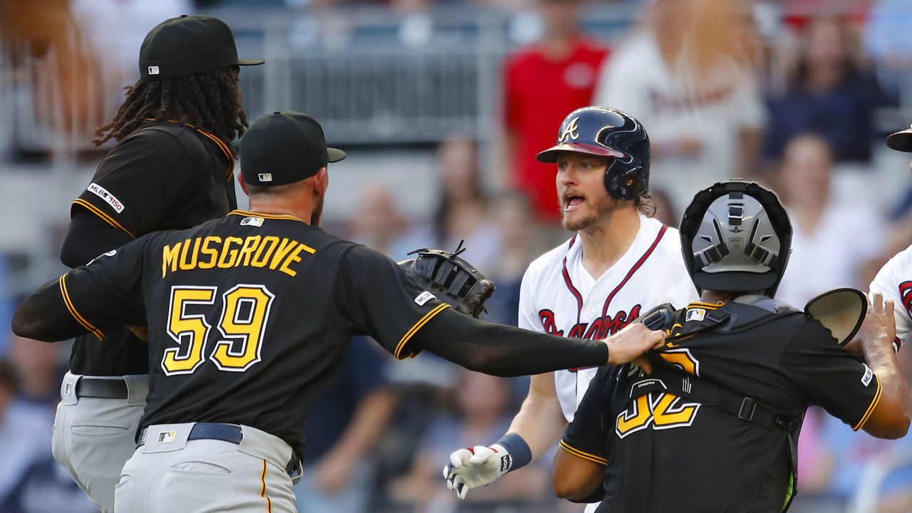 ATLANTA, GA - JUNE 10: Josh Donaldson #20 of the Atlanta Braves is restrained after being hit by a pitch as he charges Joe Musgrove #59 of the Pittsburgh Pirates during the first inning of an MLB game at SunTrust Park on June 10, 2019 in Atlanta, Georgia.