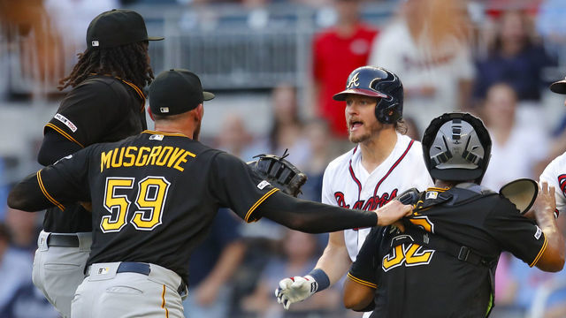 ATLANTA, GA - JUNE 10: Josh Donaldson #20 of the Atlanta Braves is restrained after being hit by a pitch as he charges Joe Musgrove #59 of the Pittsburgh Pirates during the first inning of an MLB game at SunTrust Park on June 10, 2019 in Atlanta, Georgia.