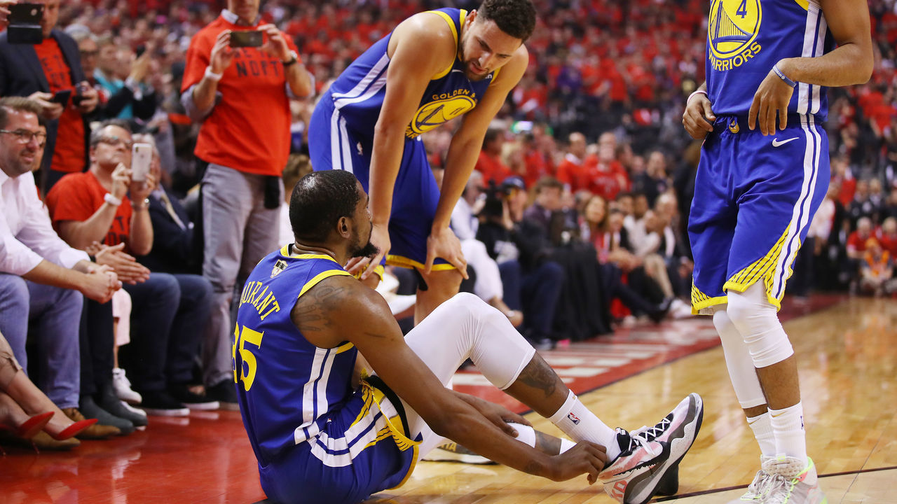 TORONTO, ONTARIO - JUNE 10: Klay Thompson #11 of the Golden State Warriors helps Kevin Durant #35 to his feet in the first half against the Toronto Raptors during Game Five of the 2019 NBA Finals at Scotiabank Arena on June 10, 2019 in Toronto, Canada.
