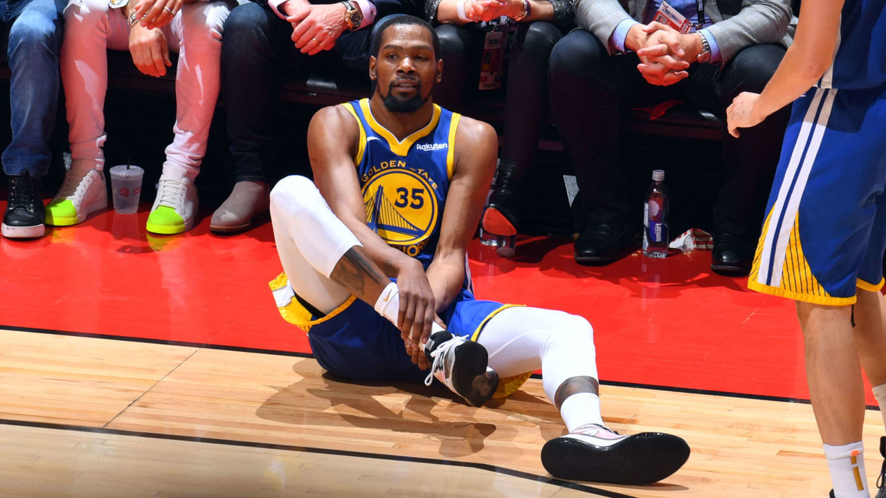 TORONTO, CANADA - JUNE 10: Kevin Durant #35 of the Golden State Warriors reacts to his leg injury during a game against the Toronto Raptors during Game Five of the NBA Finals on June 10, 2019 at Scotiabank Arena in Toronto, Ontario, Canada. NOTE TO USER: User expressly acknowledges and agrees that, by downloading and/or using this photograph, user is consenting to the terms and conditions of the Getty Images License Agreement. Mandatory Copyright Notice: Copyright 2019 NBAE