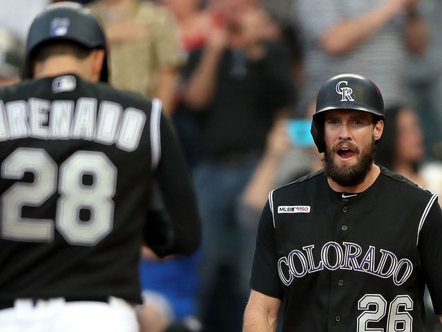 DENVER, COLORADO - JUNE 10: David Dahl #26 of the Colorado Rockies celebrates as Nolan Arenado #28 scores after hitting a 2 RBI home run in the third inning against the Chicago Cubs at Coors Field on June 10, 2019 in Denver, Colorado.