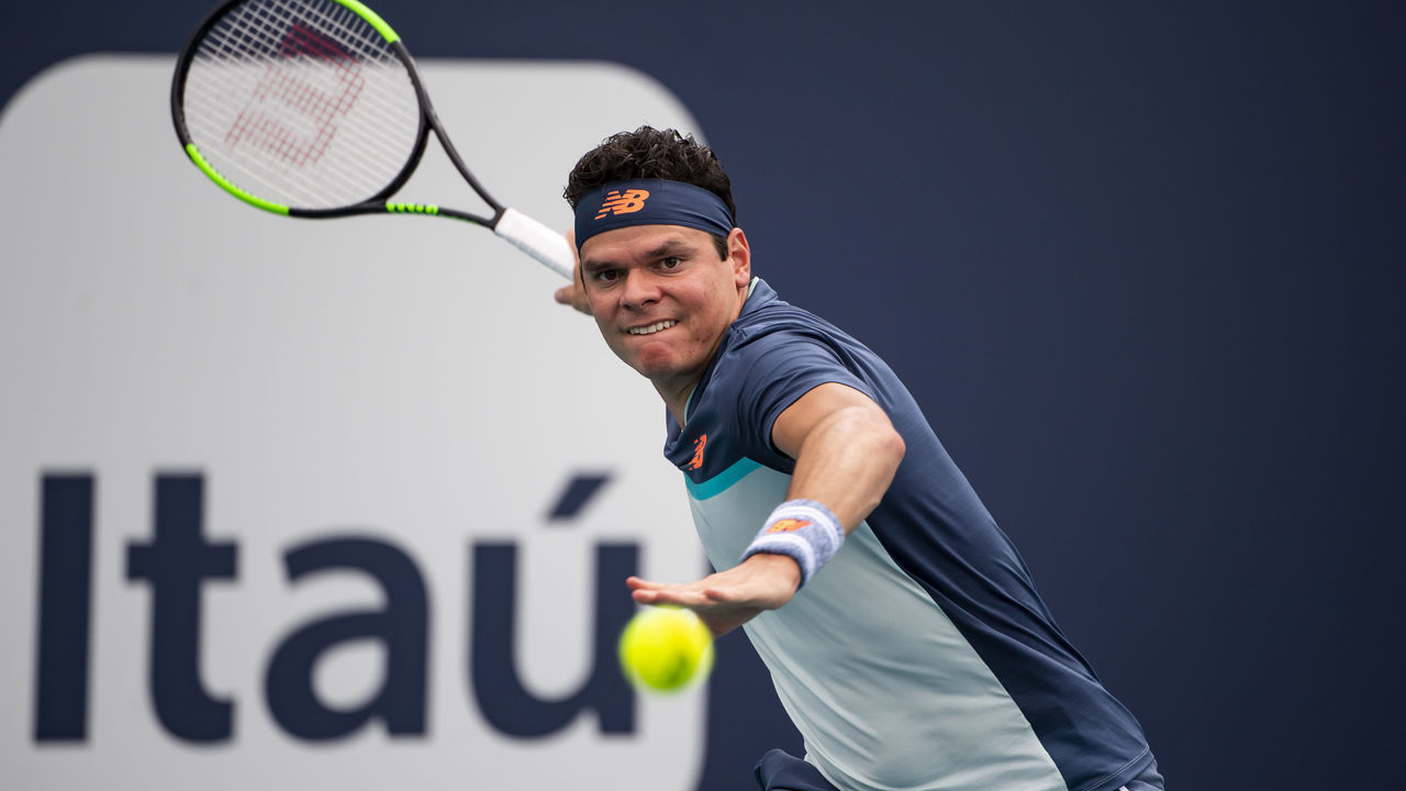 MIAMI GARDENS, FLORIDA - MARCH 24: Milos Raonic of Canada hits a forehand against Kyle Edmund of Great Britain in the third round of the men's singles in the Miami Open at the Hard Rock Stadium on March 24, 2019 in Miami Gardens, Florida.