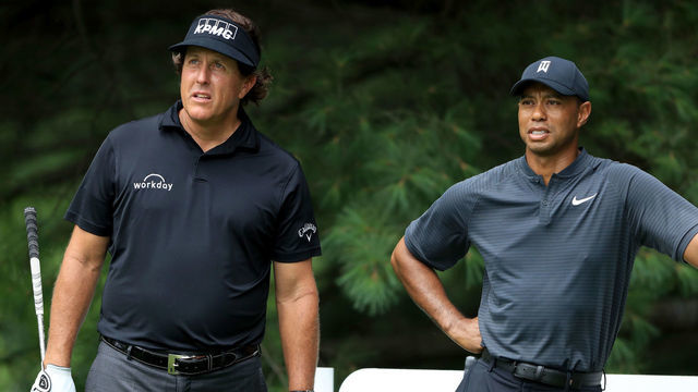 AKRON, OH - AUGUST 01: Phil Mickelson (L) and Tiger Woods meet during a preview day of the World Golf Championships - Bridgestone Invitational at Firestone Country Club South Course at on August 1, 2018 in Akron, Ohio.