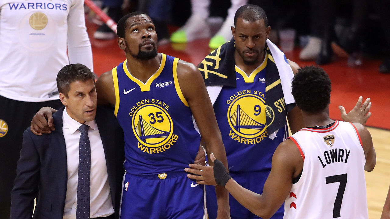 TORONTO, ONTARIO - JUNE 10: Kyle Lowry #7 of the Toronto Raptors reacts as Kevin Durant #35 of the Golden State Warriors is carried off the court in the first half during Game Five of the 2019 NBA Finals at Scotiabank Arena on June 10, 2019 in Toronto, Canada.