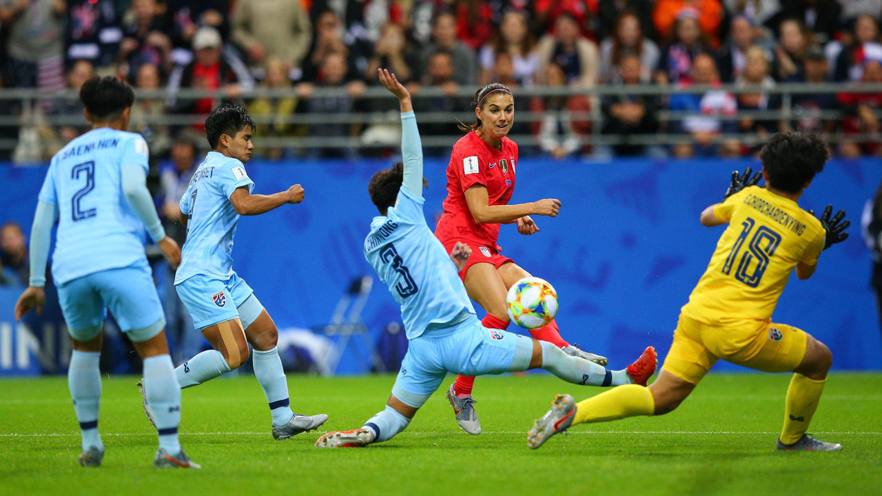 REIMS, FRANCE - JUNE 11: Alex Morgan of USA shoots at goal under pressure from Natthakarn Chinwong of Thailand during the 2019 FIFA Women's World Cup France group F match between USA and Thailand at Stade Auguste Delaune on June 11, 2019 in Reims, France.