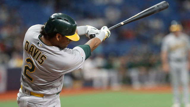 ST. PETERSBURG, FL - JUN 11: Khris Davis (2) of the Athletics drives this pitch over the fence for a home run during the MLB regular season game between the Oakland Athletics and the Tampa Bay Rays on June 11, 2019, at Tropicana Field in St. Petersburg, FL.