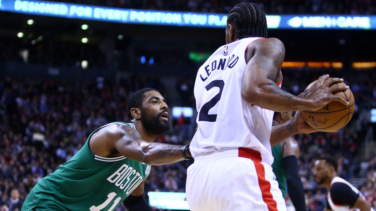TORONTO, ON - FEBRUARY 26: Kawhi Leonard #2 of the Toronto Raptors dribbles the ball as Kyrie Irving #11 of the Boston Celtics defends during the second half of an NBA game at Scotiabank Arena on February 26, 2019 in Toronto, Canada.