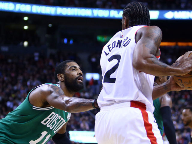 TORONTO, ON - FEBRUARY 26: Kawhi Leonard #2 of the Toronto Raptors dribbles the ball as Kyrie Irving #11 of the Boston Celtics defends during the second half of an NBA game at Scotiabank Arena on February 26, 2019 in Toronto, Canada.