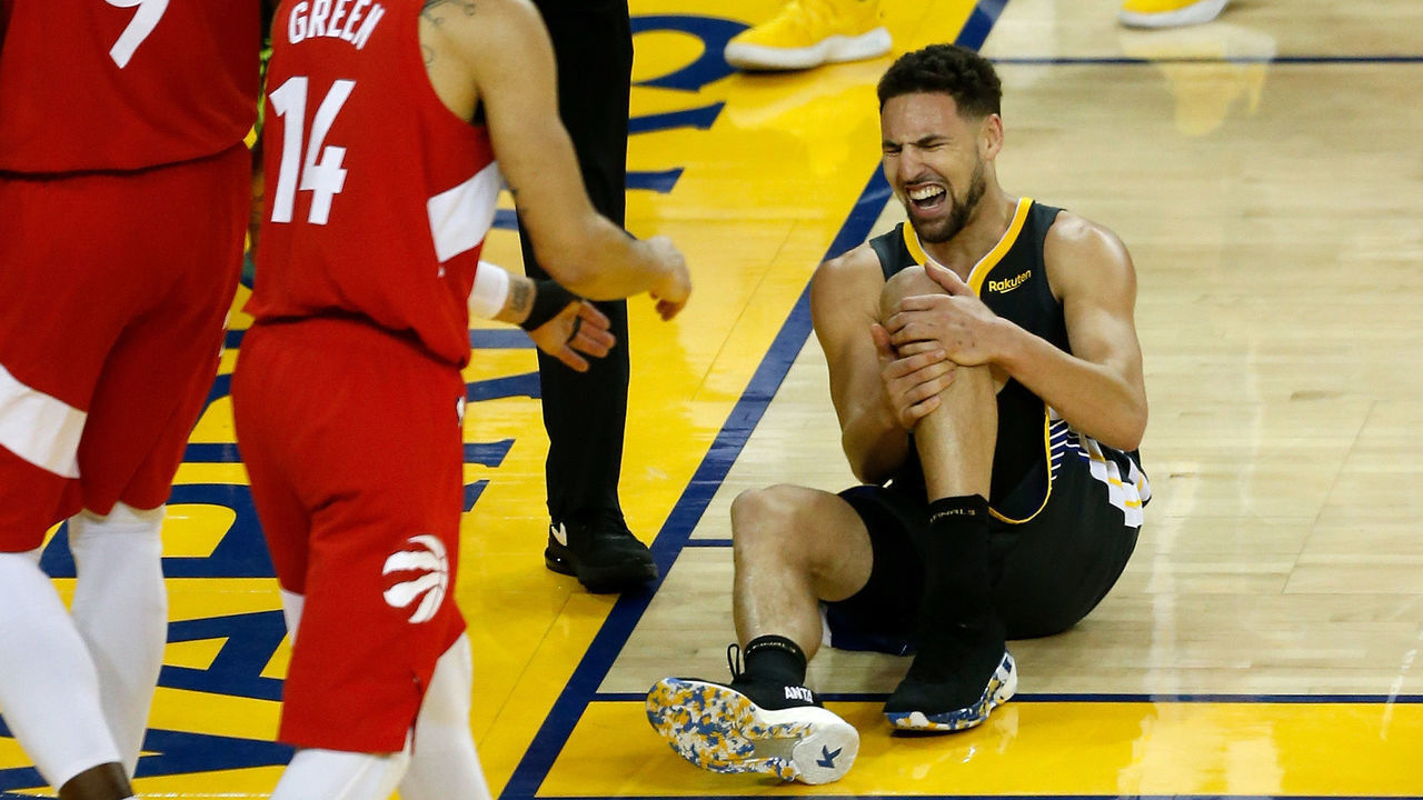 OAKLAND, CALIFORNIA - JUNE 13: Klay Thompson #11 of the Golden State Warriors reacts after hurting his leg against the Toronto Raptors in the second half during Game Six of the 2019 NBA Finals at ORACLE Arena on June 13, 2019 in Oakland, California.