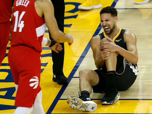 OAKLAND, CALIFORNIA - JUNE 13: Klay Thompson #11 of the Golden State Warriors reacts after hurting his leg against the Toronto Raptors in the second half during Game Six of the 2019 NBA Finals at ORACLE Arena on June 13, 2019 in Oakland, California.