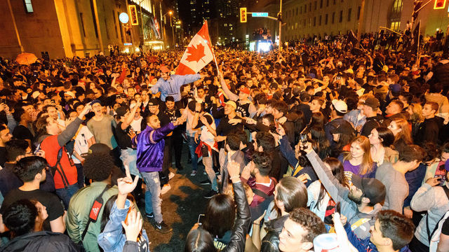 TORONTO, ON - JUNE 13: Toronto fans celebrate the win after Toronto Raptors defeated the Golden State Warriors in Game 6 of the 2019 NBA Finals on June 13, 2019 on the streets of Toronto, ON, Canada.