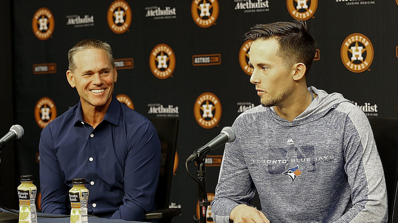 HOUSTON, TEXAS - JUNE 14: Cavan Biggio of the Toronto Blue Jays answers questions from the media as his father Craig Biggio looks on about his emotions are playing in the major leagues and playing this weekend where is hall of famer father Craig Biggio played for so many years at Minute Maid Park on June 14, 2019 in Houston, Texas.
