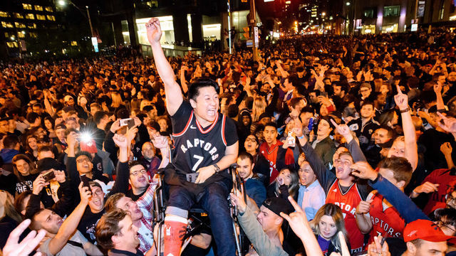 TORONTO, ON - JUNE 13: Toronto fans celebrate the win after Toronto Raptors defeated the Golden State Warriors in Game 6 of the 2019 NBA Finals on June 13, 2019 on the streets of Toronto, ON, Canada.