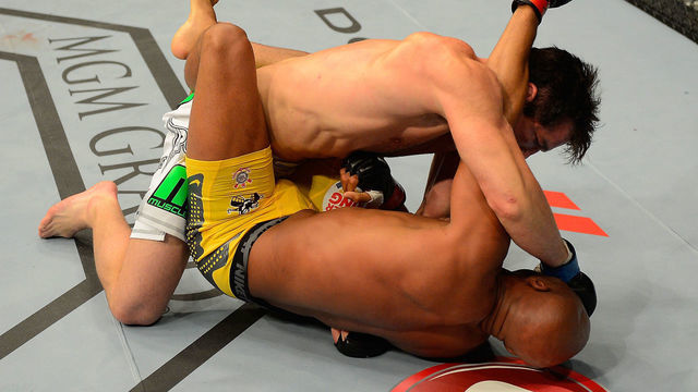 LAS VEGAS, NV - JULY 7: Chael Sonnen (top) punches Anderson Silva during their UFC middleweight championship bout at UFC 148 inside MGM Grand Garden Arena on July 7, 2012 in Las Vegas, Nevada.