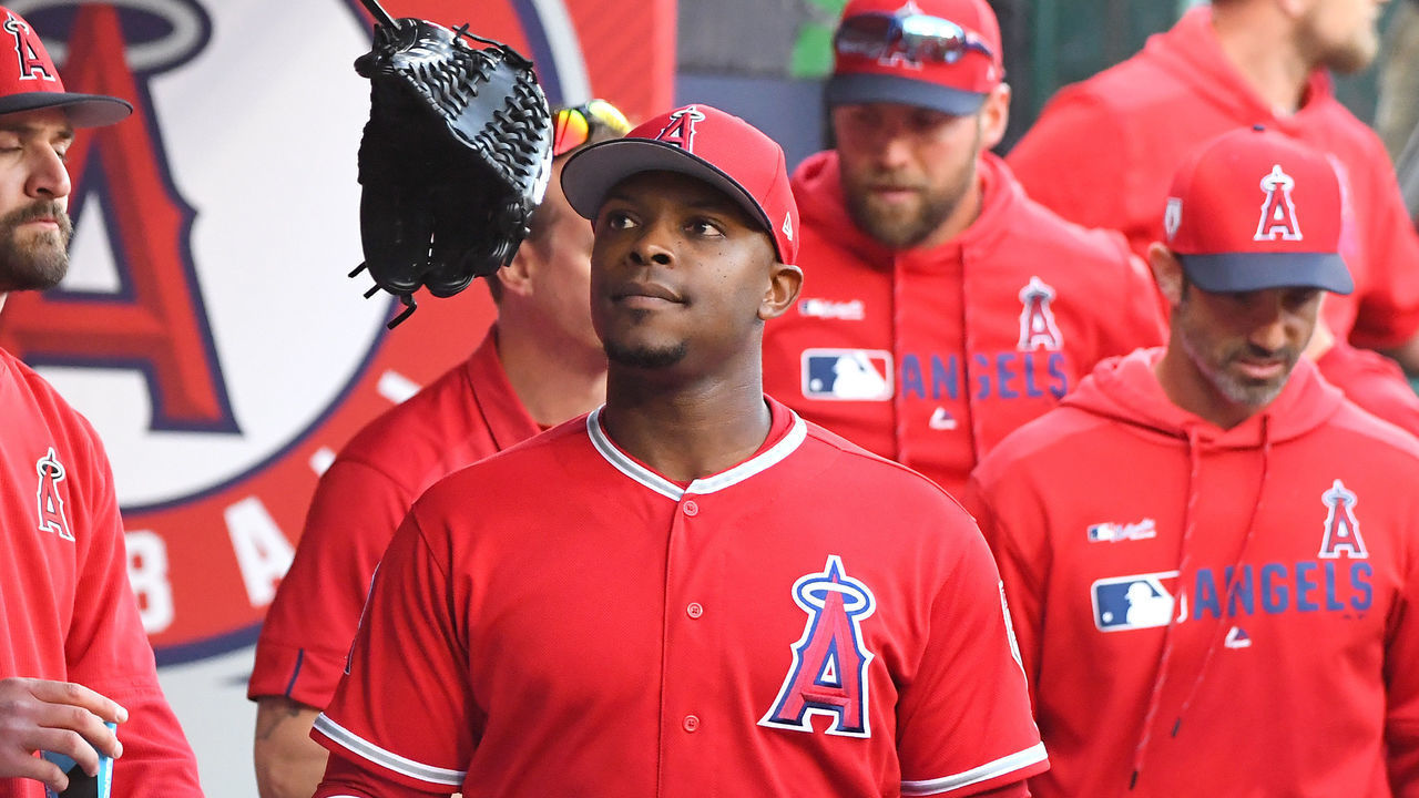 ANAHEIM, CA - MARCH 24: Justin Upton #8 of the Los Angeles Angels of Anaheim tosses his glove in the dugout after he was injured and left the game in the first inning against the Los Angeles Dodgers at Angel Stadium of Anaheim on March 24, 2019 in Anaheim, California.