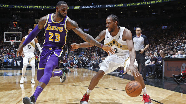 TORONTO, CANADA - MARCH 14: Kawhi Leonard #2 of the Toronto Raptors handles the ball against LeBron James #23 of the Los Angeles Lakers on March 14, 2019 at the Scotiabank Arena in Toronto, Ontario, Canada. Mandatory Copyright Notice: Copyright 2019 NBAE