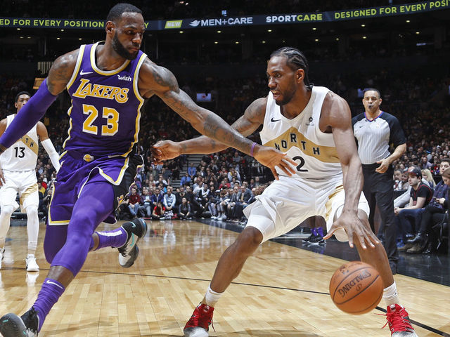 TORONTO, CANADA - MARCH 14: Kawhi Leonard #2 of the Toronto Raptors handles the ball against LeBron James #23 of the Los Angeles Lakers on March 14, 2019 at the Scotiabank Arena in Toronto, Ontario, Canada. Mandatory Copyright Notice: Copyright 2019 NBAE