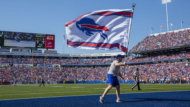 ORCHARD PARK, NY - SEPTEMBER 24: A member of the Buffalo Bills stadium crew waves a team flag to celebrate a scoring drive against the Denver Broncos on September 24, 2017 at New Era Field in Orchard Park, New York. Buffalo defeats denver 26-16. *** Local Caption ***