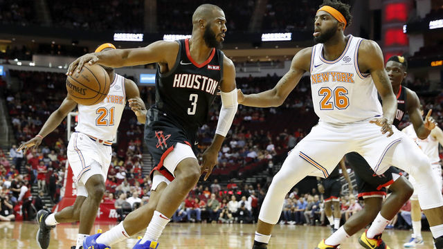 HOUSTON, TX - APRIL 05: Chris Paul #3 of the Houston Rockets drives to the basket defended by Mitchell Robinson #26 of the New York Knicks in the first half at Toyota Center on April 5, 2019 in Houston, Texas.