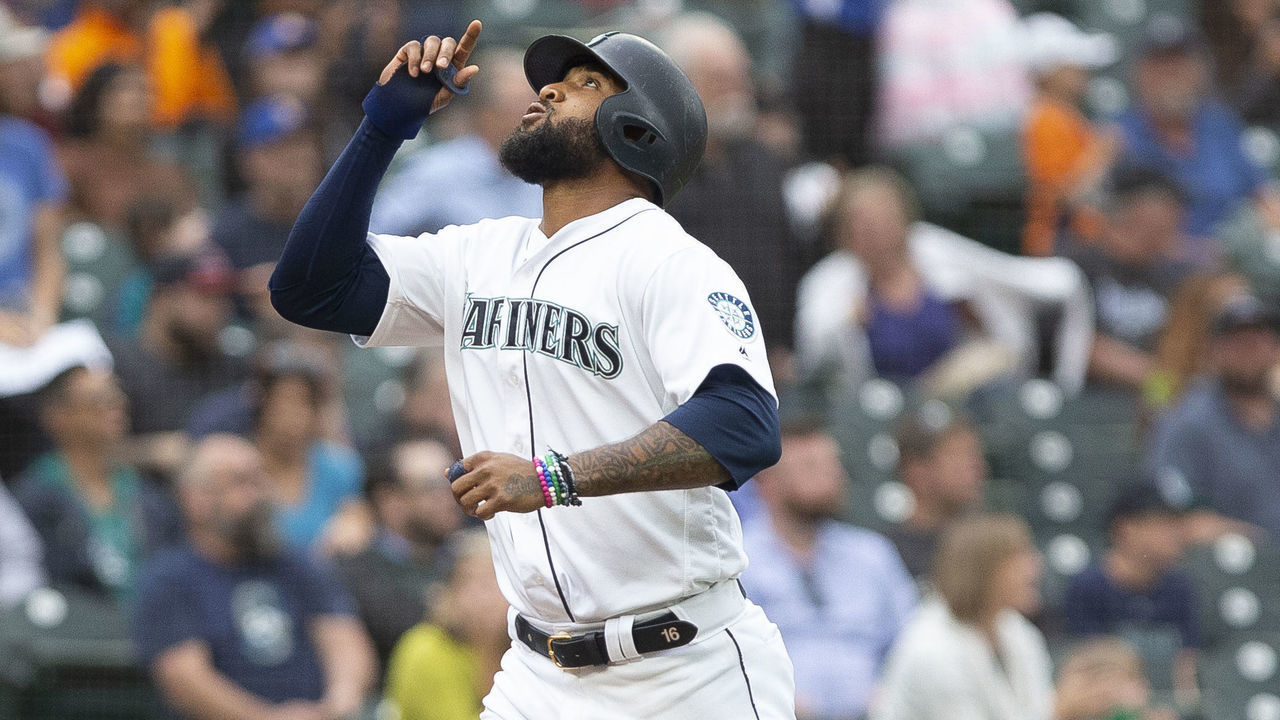 SEATTLE, WA - JUNE 19: Domingo Santana #16 of the Seattle Mariners points to the sky as he jogs to home after hitting a home run in the sixth inning against the Kansas City Royals at T-Mobile Park on June 19, 2019 in Seattle, Washington.