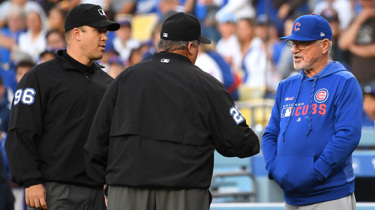 LOS ANGELES, CA - JUNE 14: Umpires Fieldin Culbreth #25 and Chris Segal talks with Joe Maddon #70 of the Chicago Cubs as he requests a challenge on a play in the game against the Los Angeles Dodgers at Dodger Stadium on June 14, 2019 in Los Angeles, California.