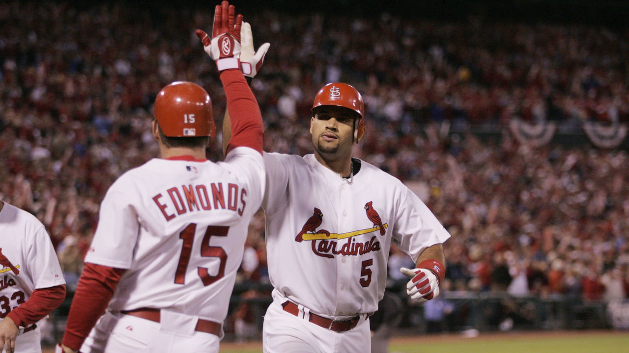 ST. LOUIS - OCTOBER 13: Albert Pujols is congratulated by Jim Edmonds of the St. Louis Cardinals after hitting a home run during the first inning of game one of the NLCS against the Houston Astros at Busch Stadium on October 13, 2004 in St. Louis, Missouri. The Cards defeated the Astros 10-7.