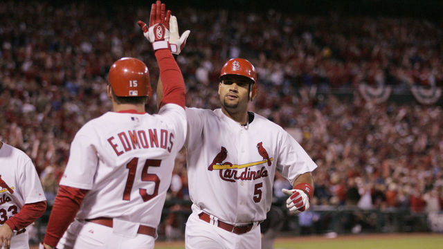 ST. LOUIS - OCTOBER 13: Albert Pujols is congratulated by Jim Edmonds of the St. Louis Cardinals after hitting a home run during the first inning of game one of the NLCS against the Houston Astros at Busch Stadium on October 13, 2004 in St. Louis, Missouri. The Cards defeated the Astros 10-7.