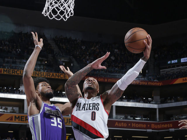 SACRAMENTO, CA - JANUARY 14: Damian Lillard #0 of the Portland Trail Blazers goes up for the shot against Marvin Bagley III #35 of the Sacramento Kings on January 14, 2019 at Golden 1 Center in Sacramento, California. NOTE TO USER: User expressly acknowledges and agrees that, by downloading and or using this photograph, User is consenting to the terms and conditions of the Getty Images Agreement. Mandatory Copyright Notice: Copyright 2019 NBAE